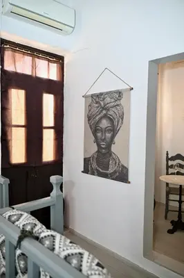 a picture of a woman on a wall in a room at PENELOPE garden house old town in Rhodes Town
