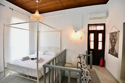 a white room with a bed in a room at PENELOPE garden house old town in Rhodes Town
