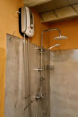 a shower with a phone on the wall in a bathroom at PENELOPE garden house old town in Rhodes Town