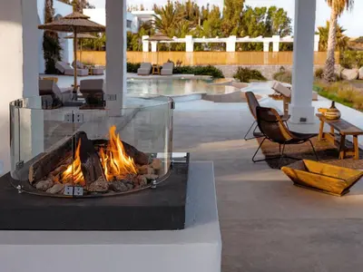 a fire pit sitting on a table next to a patio at Exquisite Rhodes Villa Villa Boho Chic 6 Bedrooms Private Pool in Lachania