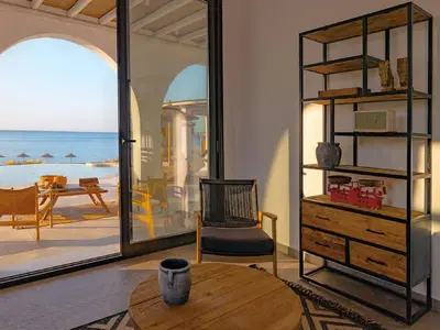 a living room with a table and a mirror at Exquisite Rhodes Villa Villa Boho Chic 6 Bedrooms Private Pool in Lachania