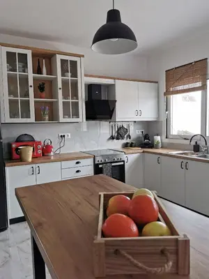 a kitchen with a wooden box of fruit on a table at Mika's B luxury House near Faliraki in Kalithies
