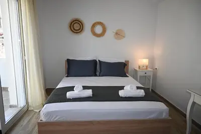 a bedroom with a bed with towels on it at Mika's B luxury House near Faliraki in Kalithies