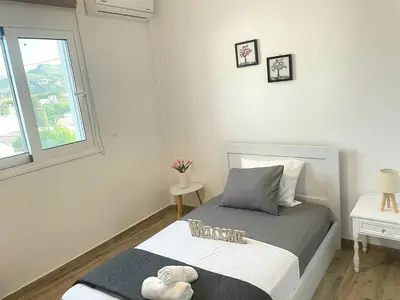 a small bedroom with a bed and a window at Mika's B luxury House near Faliraki in Kalithies