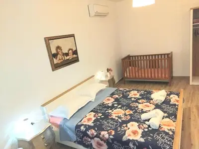 a bedroom with a bed with a crib and a picture at Mika's B luxury House near Faliraki in Kalithies
