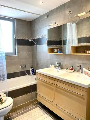 a bathroom with a sink and a tub and a toilet at Diamond Rod Villa near Faliraki in Kalithies