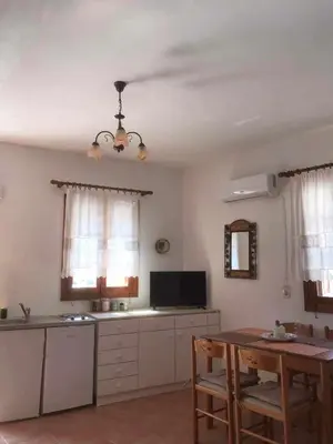 a kitchen with a table and a dining room at Dimitras Studio in Arnítha