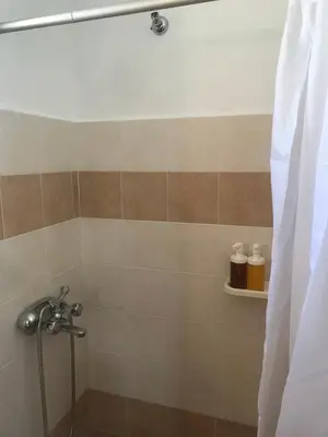 a bathroom with a shower with a shower curtain at Dimitras Studio in Arnítha