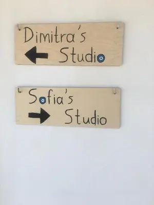 two signs with arrows pointing touador and santiago at Dimitras Studio in Arnítha