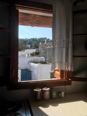 an open window with a view of a building at Dimitras Studio in Arnítha