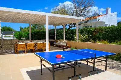 a blue ping pong table on a patio at Eternity Villa Kolympia in Kolimbia