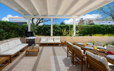 a patio with a table and chairs and a grill at Eternity Villa Kolympia in Kolimbia