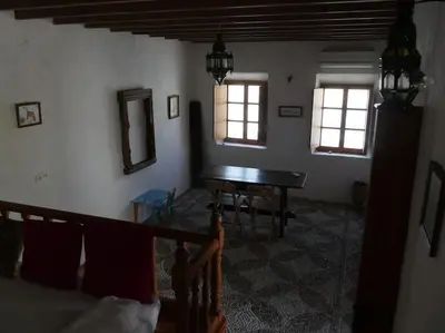 a living room with a table and a bed at Lindos Traditional House in Rhodes Town