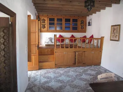 a bedroom with a bed with red pillows at Lindos Traditional House in Rhodes Town