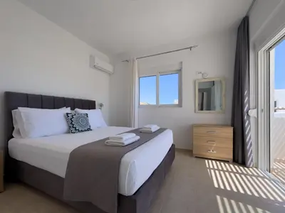 a bedroom with a bed and a large window at Villa Marina - Glystra Beach in Kiotari