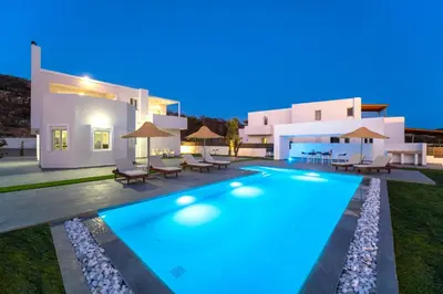 a villa with a swimming pool at night at Villa Marina - Glystra Beach in Kiotari