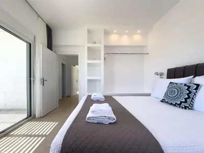 a bedroom with a large bed and a large window at Villa Marina - Glystra Beach in Kiotari