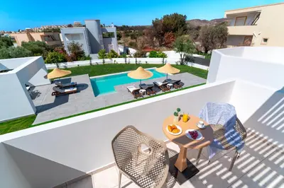 a view from the balcony of a villa with a swimming pool at Villa Marina - Glystra Beach in Kiotari