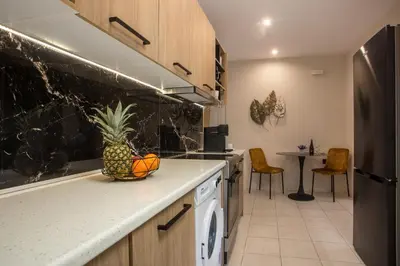 a kitchen with a pineapple in a bowl on the counter at JnS Premium Stay in Faliraki