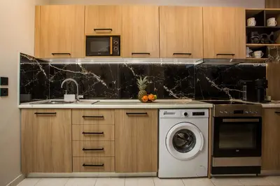 a kitchen with a sink and a washing machine at JnS Premium Stay in Faliraki