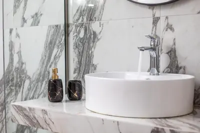 a bathroom with a white sink and a mirror at JnS Premium Stay in Faliraki