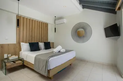 a bedroom with a bed with a mirror and a tv at JnS Premium Stay in Faliraki