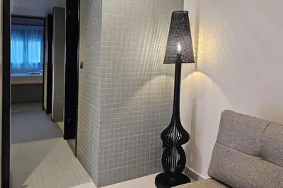 a lamp sitting next to a couch in a room at MINT in Rhodes Town