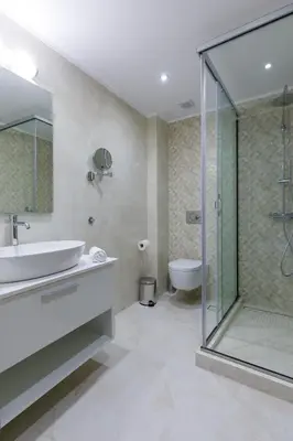 a bathroom with a shower and a sink and a toilet at Lindian Villas in Líndos