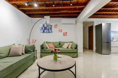 a living room with two green couches and a table at Lindian Villas in Líndos