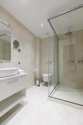 a bathroom with a shower and a sink and a toilet at Lindian Villas in Líndos