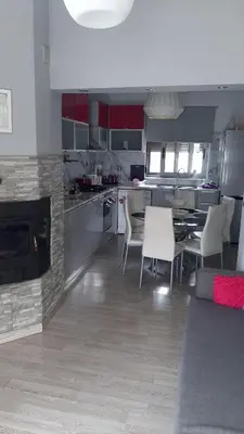 a kitchen with a table and chairs in a kitchen at Isaias house in Rhodes Town