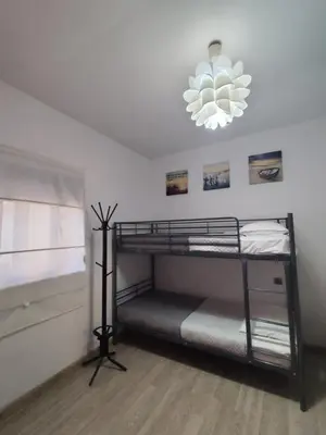 a bedroom with two bunk beds and a chandelier at Isaias house in Rhodes Town