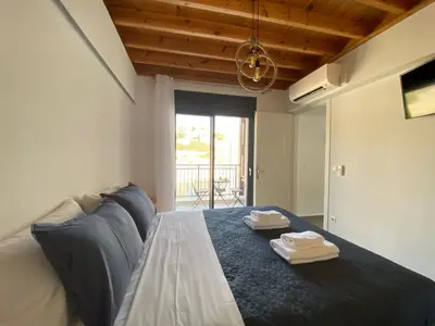 a bedroom with a bed with two towels on it at Pefkos Vista Luxury Villas in Pefki Rhodes