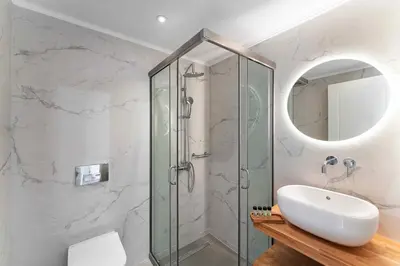a bathroom with a glass shower and a sink at Pefkos Vista Luxury Villas in Pefki Rhodes