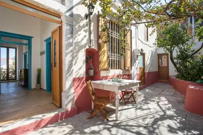 a table and chairs sitting outside of a building at Galini & Serena Apartments in Symi