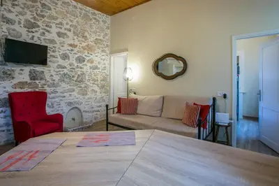a living room with a table and a couch at Galini & Serena Apartments in Symi