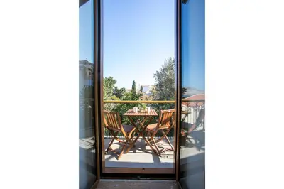 a view of a table and chairs through a glass door at Galini & Serena Apartments in Symi