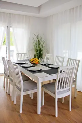 a white dining room table with white chairs and a white table and chairsktop at Villa Dana in Ixia