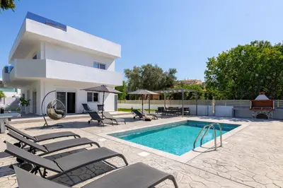 a villa with a swimming pool and a house at Villa Dana in Ixia