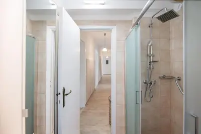 a bathroom with a walk in shower and a glass shower stall at Plumeria Alba Apartment in Rhodes Town