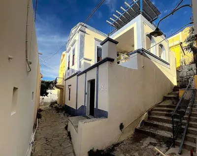 a building with stairs leading up to it at Symi Blue Studio in Symi