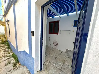 an open door to a white and blue building at Symi Blue Studio in Symi