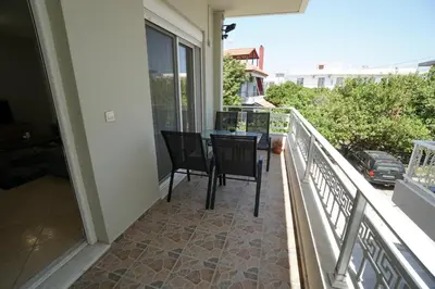 a balcony with a table and chairs on a balcony at Anna's Apartments in Kremasti