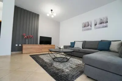 a living room with a couch and a table at Anna's Apartments in Kremasti