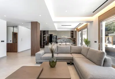 a living room with a couch and a table at Emerald & Ruby Villas in Asgourou