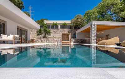 a swimming pool in the backyard of a house at Emerald & Ruby Villas in Asgourou