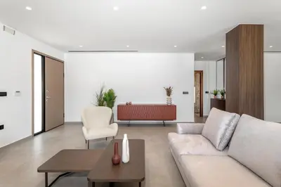 a living room with a couch and a table at Emerald & Ruby Villas in Asgourou