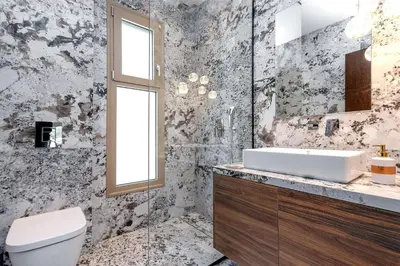 a bathroom with a sink and a toilet and a mirror at Emerald & Ruby Villas in Asgourou