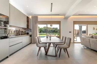 a kitchen and dining room with a table and chairs at Emerald & Ruby Villas in Asgourou