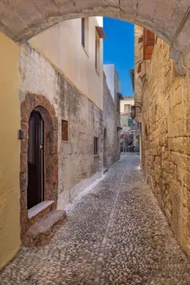 an alley with an arch in a stone building at Majestic Marble Retreat in Rhodes Town